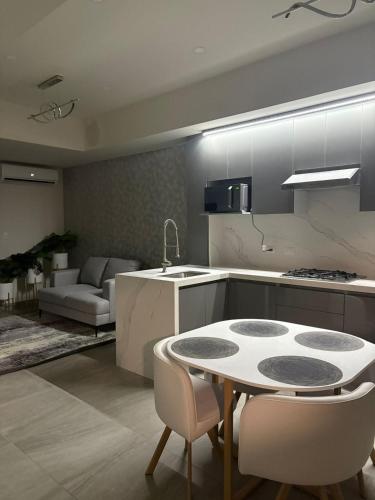 a kitchen with a table and some chairs in a room at Elegante departamento a 10 minutos de Cintermex in Monterrey