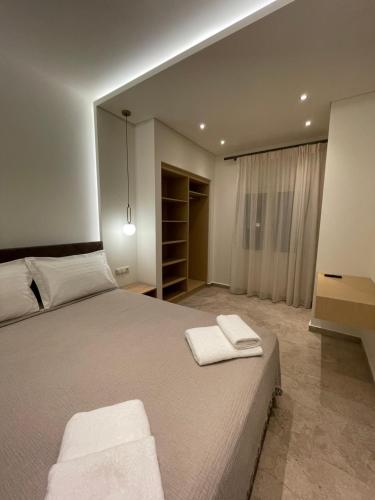 Postel nebo postele na pokoji v ubytování Tsoukos Apartments