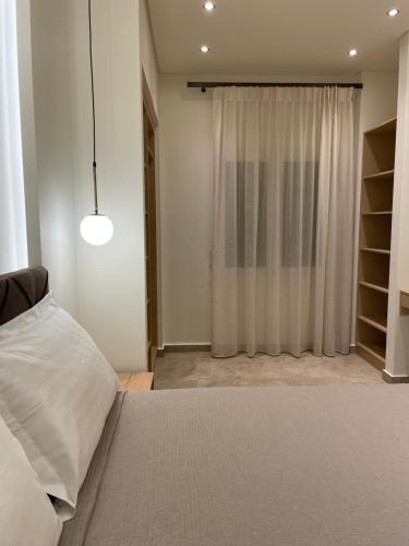 Postel nebo postele na pokoji v ubytování Tsoukos Apartments