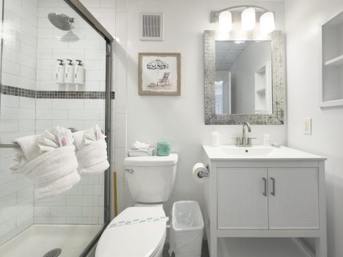 a bathroom with a toilet and a sink and a shower at Windward Shores in Amagansett