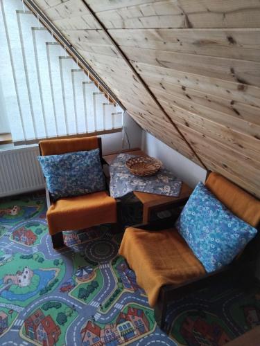 a room with two chairs and a table and a rug at Chata Pavla in Jablonec nad Nisou