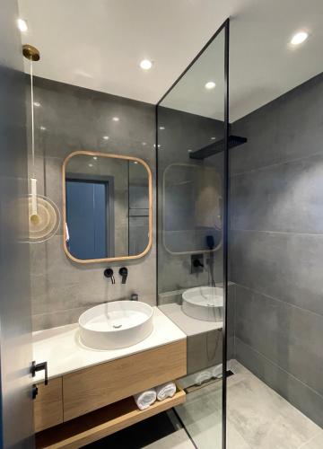 a bathroom with two sinks and a mirror at Bamboo Beach Tsikhisdziri, Solmare Loft in Itʼkhvisi