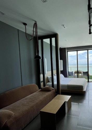 a hotel room with a bed and a couch at Bamboo Beach Tsikhisdziri, Solmare Loft in Itʼkhvisi