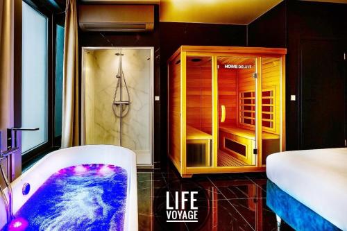 a bathroom with a bath tub and a life vapore at LIFE VOYAGE & SPA - Strasbourg's City Center Luxury Experience in Strasbourg