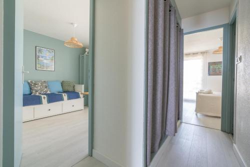 a bedroom with a bed and a mirror at Corniche Azur YourHostHelper in Sète