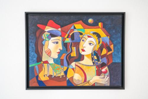a painting of two women with an umbrella at Corniche Azur YourHostHelper in Sète