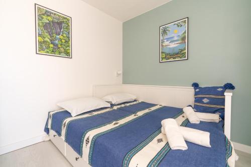 a bedroom with two beds with towels on them at Corniche Azur YourHostHelper in Sète