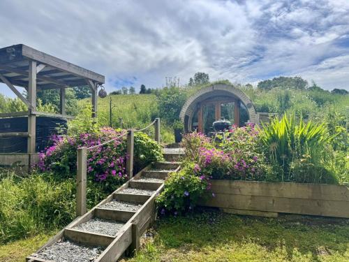 a garden with flowers and a gazebo at 1 Bed in Llanidloes 81415 in Van
