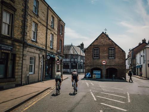 two people riding bikes down a city street at 1 Bed in Llanidloes 81415 in Van
