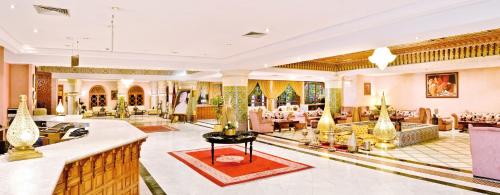 a lobby of a hotel with couches and tables at Zalagh Parc Palace in Fès