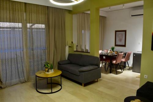 a living room with a couch and a table at SeaBreeze Penthouse with Private Parking in Alexandroupoli