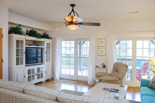Una sala de estar con un sofá y un televisor. en Reelaxation, en Kill Devil Hills