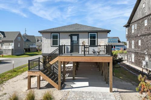 a home with a deck with a house at Salt Box in Nags Head