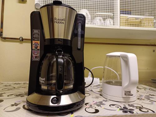 a coffeemaker sitting on a table next to a coffee maker at Guest house in Datteln in Datteln