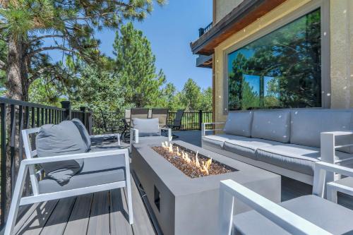 a patio with a couch and a fire pit at Oak Hills Estate Luxe Forest Escape Near USAFA in Monument