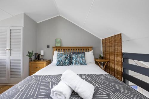 a bedroom with a bed with towels on it at Brighton Water Cabin at the Marina, Free Parking By My Getaways in Brighton & Hove