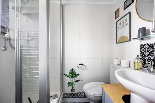a bathroom with a shower and a toilet and a sink at Brighton Water Cabin at the Marina, Free Parking By My Getaways in Brighton & Hove