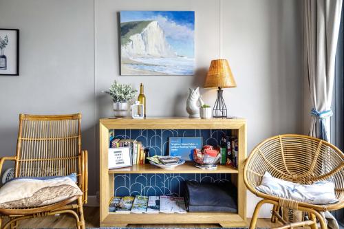 a room with two chairs and a book shelf at Brighton Water Cabin at the Marina, Free Parking By My Getaways in Brighton & Hove
