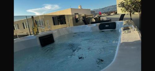 a swimming pool on the roof of a building at Bella Vista Sunset penthouse with private jacuzzi in Novalja