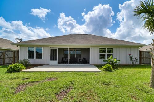 a home with a palm tree in the yard at Home 12 Mi to Gulf Shores Beach and Boardwalk! in Foley