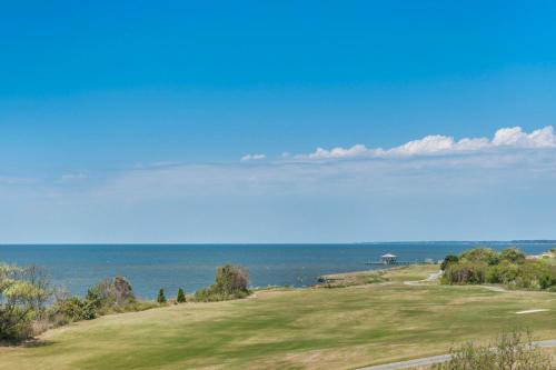 a golf course with the ocean in the background at Sand Hills South in Nags Head