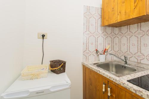 a kitchen with a sink and a counter top at Antico Monastero in Bitonto