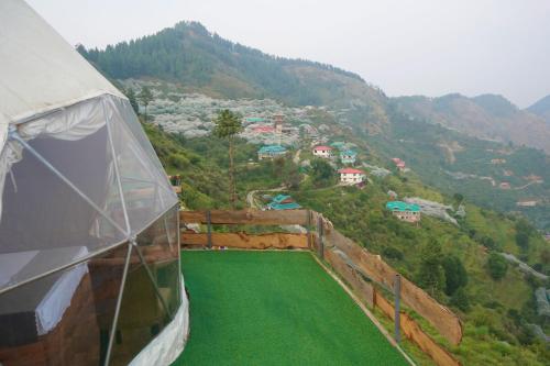 a view from the inside of a tent on a mountain at The Astro Orchard in Shimla
