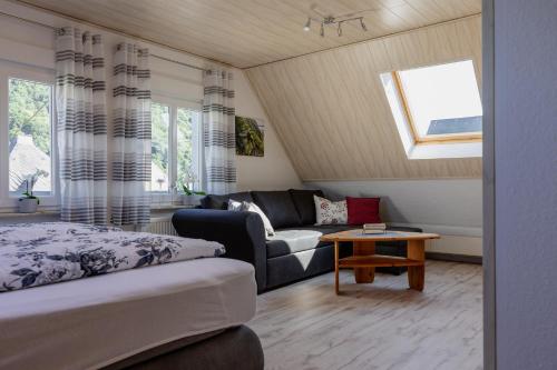 a living room with a bed and a couch at Ferienwohnung Moselurlaub Winningen in Winningen