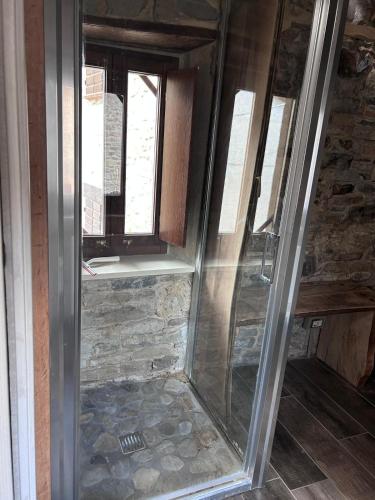 a glass shower in a room with a window at Il nido di Matilde in Rossena
