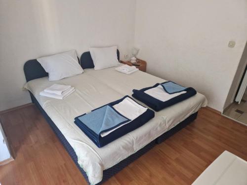 a bedroom with a bed with towels on it at Apartments Picioski in Peštani