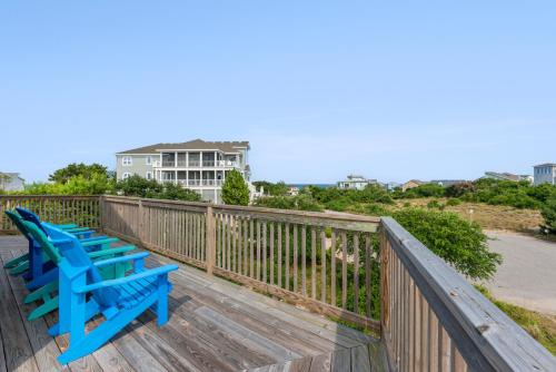 two blue benches sitting on a wooden deck at Sandhill Unit in Duck