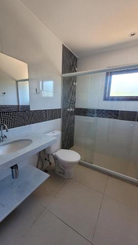a bathroom with a toilet and a sink and a shower at Turtle house 1 in Búzios