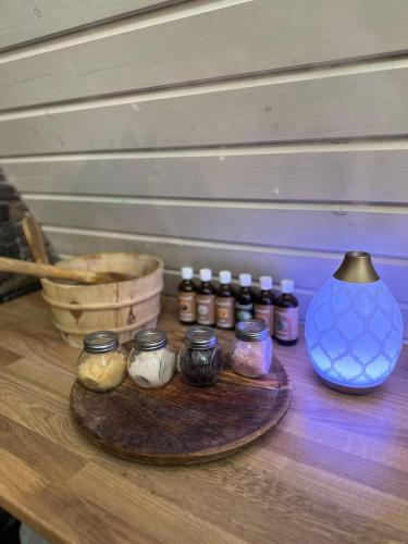 a wooden table with jars of herbs and a blue vase at A-Frame Bosanci in Bosanci