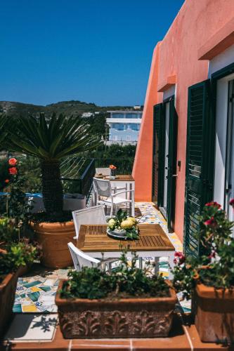 a table and chairs on the balcony of a building at Hotel Villa Maria in Ischia