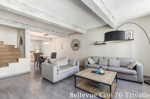 a living room with a couch and a table at Les Bellevue Cité Trivalle "3 Apartments, 1 with Terrace & Private Parking, Aircon, WiFi, 500m from Cité, free public car park 200m" in Carcassonne