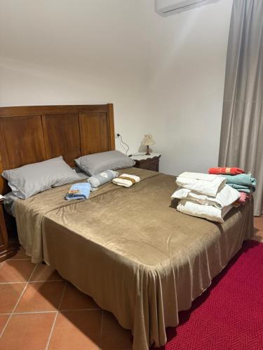 a bed with towels sitting on top of it at Affittacamere Del Piano - Private Parking in Orvieto Scalo