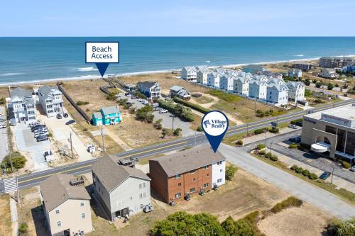 an aerial view of a beach area with houses and the ocean at Sea Escape in Kill Devil Hills