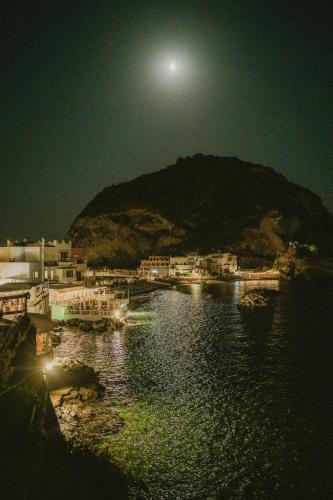 a moon over a body of water at night at Hotel Villa Maria in Ischia