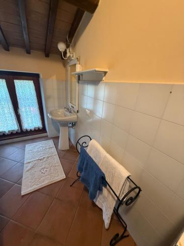 a bathroom with a sink and a towel on a rack at Affittacamere Del Piano - Private Parking in Orvieto Scalo