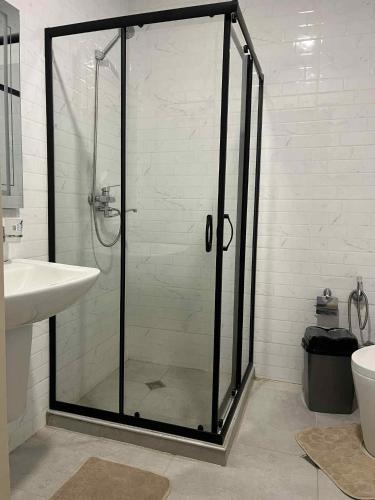 a shower with a glass door in a bathroom at Didveli rezidens in Bakuriani