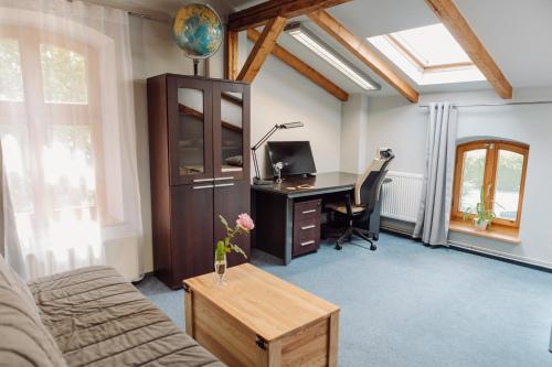 an office with a desk and a computer in a room at Apartment K21 Stare Tychy in Tychy