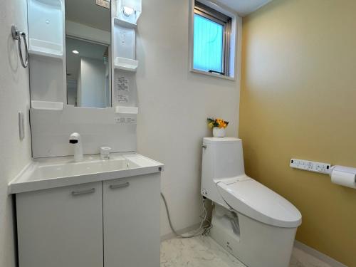 a bathroom with a toilet and a sink and a mirror at Monarch Hotel - Vacation STAY 43022v in Otaru