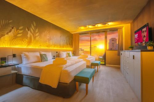 a hotel room with two beds and a tv at Deluxe Apartments in Palermo - by BueRentals in Buenos Aires