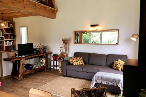 a living room with a couch and a window at Charmante maison à 5 minutes de la plage in Saint-Jean-de-Luz