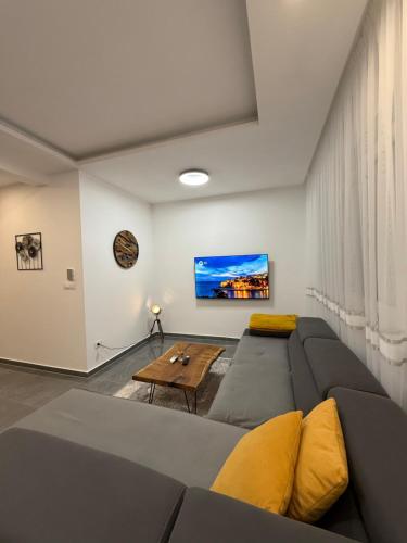 a living room with a couch and a table at Skyline View Apartment in Ulcinj
