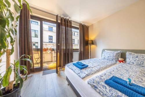 a bedroom with a bed and a large window at Gloria Apartment in Budapest