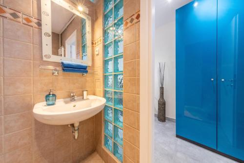 a bathroom with a sink and a mirror at Gloria Apartment in Budapest