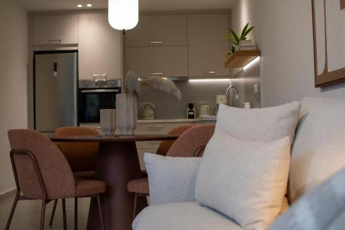 a kitchen and dining room with a table and chairs at Aigis Skiathos in Skiathos Town