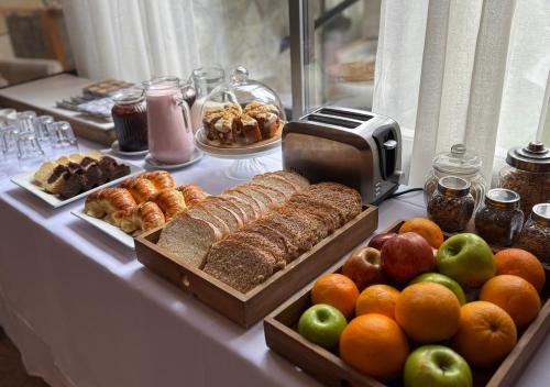 a buffet of food with bread and fruit on a table at La Comarca Resort & Spa in Villa La Angostura