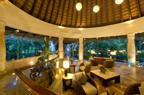 a lobby of a resort with chairs and tables at Kore Tulum Retreat & Spa Resort All Inclusive - Adults Only in Tulum